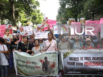 Medical students and doctors shout slogans during a protest rally towards Kolkata Police Headquarters, Lalbazar, protesting against the rape...