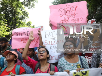 Medical students and doctors shout slogans during a protest rally towards Kolkata Police Headquarters, Lalbazar, protesting against the rape...