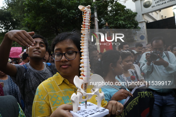 Medical students and doctors shout slogans during a protest rally towards Kolkata Police Headquarters, Lalbazar, protesting against the rape...