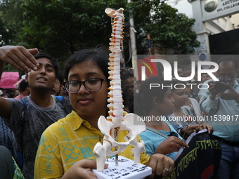 Medical students and doctors shout slogans during a protest rally towards Kolkata Police Headquarters, Lalbazar, protesting against the rape...