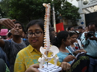 Medical students and doctors shout slogans during a protest rally towards Kolkata Police Headquarters, Lalbazar, protesting against the rape...