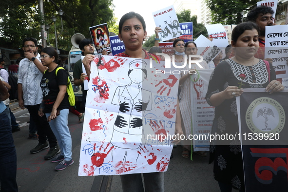 Medical students and doctors shout slogans during a protest rally towards Kolkata Police Headquarters, Lalbazar, protesting against the rape...