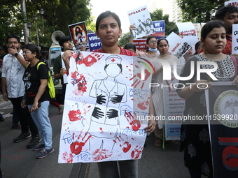 Medical students and doctors shout slogans during a protest rally towards Kolkata Police Headquarters, Lalbazar, protesting against the rape...