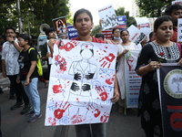 Medical students and doctors shout slogans during a protest rally towards Kolkata Police Headquarters, Lalbazar, protesting against the rape...