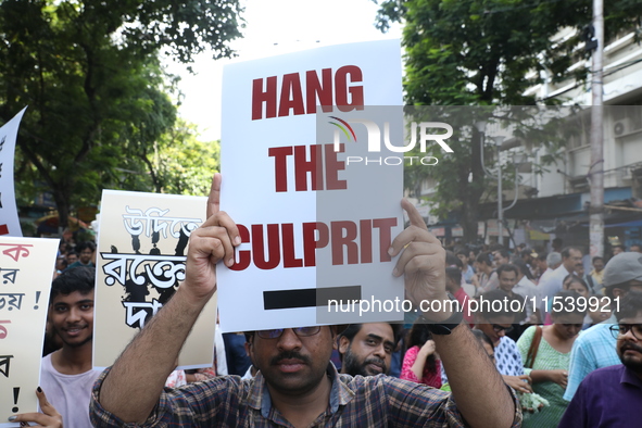 Medical students and doctors shout slogans during a protest rally towards Kolkata Police Headquarters, Lalbazar, protesting against the rape...