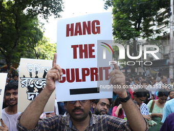 Medical students and doctors shout slogans during a protest rally towards Kolkata Police Headquarters, Lalbazar, protesting against the rape...