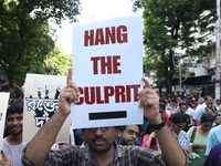 Medical students and doctors shout slogans during a protest rally towards Kolkata Police Headquarters, Lalbazar, protesting against the rape...