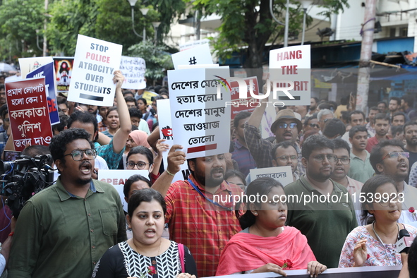 Medical students and doctors shout slogans during a protest rally towards Kolkata Police Headquarters, Lalbazar, protesting against the rape...