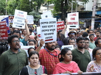 Medical students and doctors shout slogans during a protest rally towards Kolkata Police Headquarters, Lalbazar, protesting against the rape...