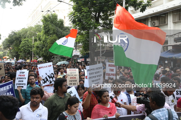 Medical students and doctors shout slogans during a protest rally towards Kolkata Police Headquarters, Lalbazar, protesting against the rape...