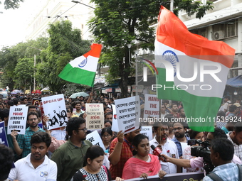 Medical students and doctors shout slogans during a protest rally towards Kolkata Police Headquarters, Lalbazar, protesting against the rape...