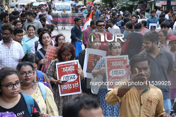 Medical students and doctors shout slogans during a protest rally towards Kolkata Police Headquarters, Lalbazar, protesting against the rape...