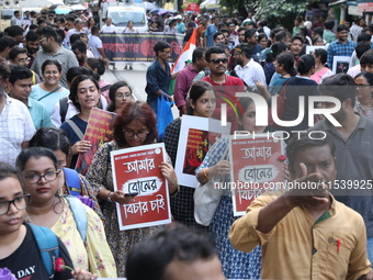 Medical students and doctors shout slogans during a protest rally towards Kolkata Police Headquarters, Lalbazar, protesting against the rape...