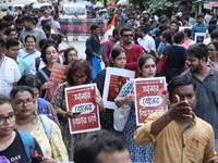 Medical students and doctors shout slogans during a protest rally towards Kolkata Police Headquarters, Lalbazar, protesting against the rape...