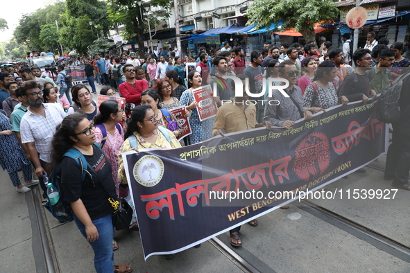 Medical students and doctors shout slogans during a protest rally towards Kolkata Police Headquarters, Lalbazar, protesting against the rape...