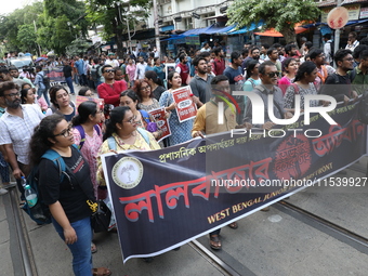 Medical students and doctors shout slogans during a protest rally towards Kolkata Police Headquarters, Lalbazar, protesting against the rape...