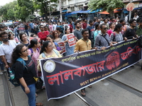 Medical students and doctors shout slogans during a protest rally towards Kolkata Police Headquarters, Lalbazar, protesting against the rape...