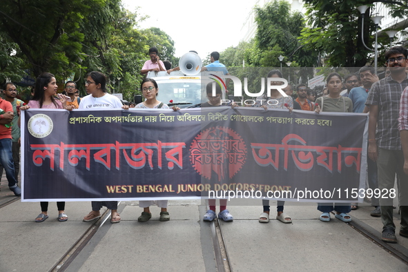 Medical students and doctors shout slogans during a protest rally towards Kolkata Police Headquarters, Lalbazar, protesting against the rape...