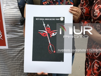 Medical students and doctors shout slogans during a protest rally towards Kolkata Police Headquarters, Lalbazar, protesting against the rape...