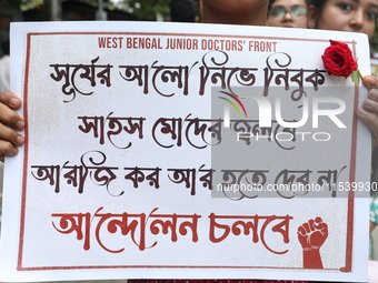 Medical students and doctors shout slogans during a protest rally towards Kolkata Police Headquarters, Lalbazar, protesting against the rape...