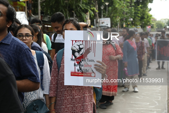 Medical students and doctors shout slogans during a protest rally towards Kolkata Police Headquarters, Lalbazar, protesting against the rape...