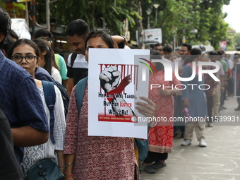 Medical students and doctors shout slogans during a protest rally towards Kolkata Police Headquarters, Lalbazar, protesting against the rape...