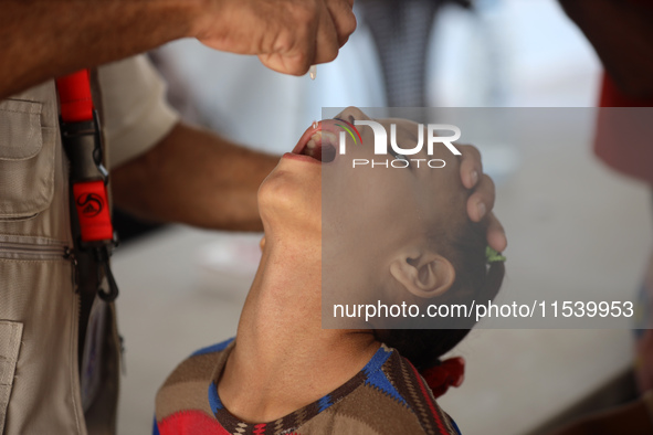 A Palestinian child receives a polio vaccination in the UK-MED field hospital in Zawayda, Gaza Strip, on September 2, 2024, amid the ongoing...