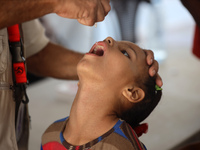 A Palestinian child receives a polio vaccination in the UK-MED field hospital in Zawayda, Gaza Strip, on September 2, 2024, amid the ongoing...