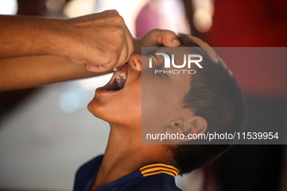 A Palestinian child receives a polio vaccination in the UK-MED field hospital in Zawayda, Gaza Strip, on September 2, 2024, amid the ongoing...