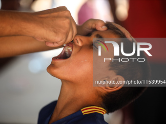 A Palestinian child receives a polio vaccination in the UK-MED field hospital in Zawayda, Gaza Strip, on September 2, 2024, amid the ongoing...