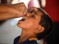 A Palestinian child receives a polio vaccination in the UK-MED field hospital in Zawayda, Gaza Strip, on September 2, 2024, amid the ongoing...