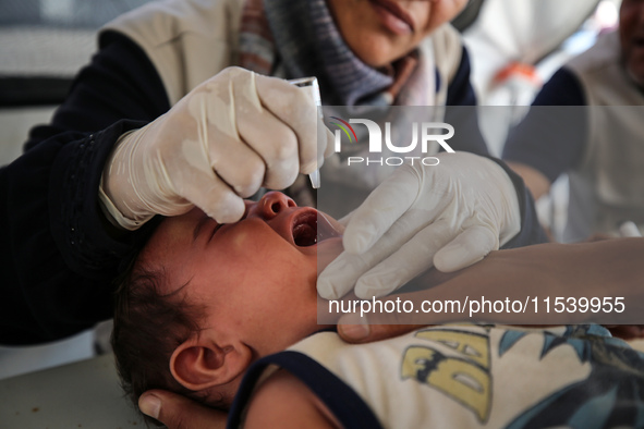 A Palestinian child receives a polio vaccination in the UK-MED field hospital in Zawayda, Gaza Strip, on September 2, 2024, amid the ongoing...