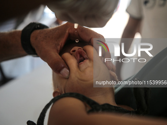 A Palestinian child receives a polio vaccination in the UK-MED field hospital in Zawayda, Gaza Strip, on September 2, 2024, amid the ongoing...