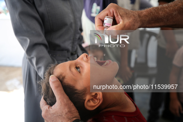 A Palestinian child receives a polio vaccination in the UK-MED field hospital in Zawayda, Gaza Strip, on September 2, 2024, amid the ongoing...