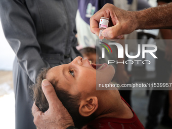 A Palestinian child receives a polio vaccination in the UK-MED field hospital in Zawayda, Gaza Strip, on September 2, 2024, amid the ongoing...