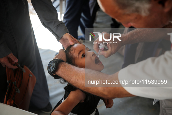 A Palestinian child receives a polio vaccination in the UK-MED field hospital in Zawayda, Gaza Strip, on September 2, 2024, amid the ongoing...