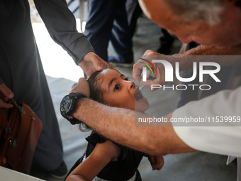 A Palestinian child receives a polio vaccination in the UK-MED field hospital in Zawayda, Gaza Strip, on September 2, 2024, amid the ongoing...