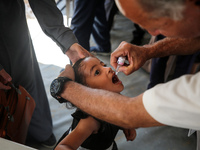 A Palestinian child receives a polio vaccination in the UK-MED field hospital in Zawayda, Gaza Strip, on September 2, 2024, amid the ongoing...