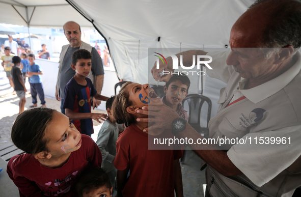 A Palestinian child receives a polio vaccination in the UK-MED field hospital in Zawayda, Gaza Strip, on September 2, 2024, amid the ongoing...