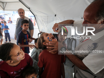 A Palestinian child receives a polio vaccination in the UK-MED field hospital in Zawayda, Gaza Strip, on September 2, 2024, amid the ongoing...