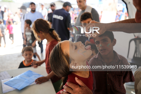 A Palestinian child receives a polio vaccination in the UK-MED field hospital in Zawayda, Gaza Strip, on September 2, 2024, amid the ongoing...