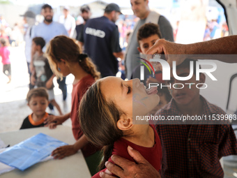 A Palestinian child receives a polio vaccination in the UK-MED field hospital in Zawayda, Gaza Strip, on September 2, 2024, amid the ongoing...