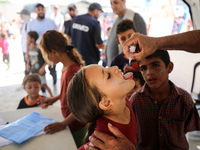 A Palestinian child receives a polio vaccination in the UK-MED field hospital in Zawayda, Gaza Strip, on September 2, 2024, amid the ongoing...