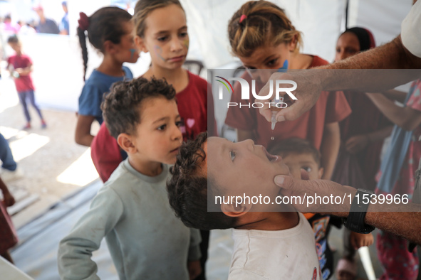 A Palestinian child receives a polio vaccination in the UK-MED field hospital in Zawayda, Gaza Strip, on September 2, 2024, amid the ongoing...