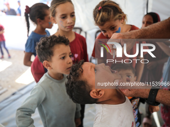 A Palestinian child receives a polio vaccination in the UK-MED field hospital in Zawayda, Gaza Strip, on September 2, 2024, amid the ongoing...