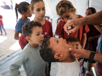 A Palestinian child receives a polio vaccination in the UK-MED field hospital in Zawayda, Gaza Strip, on September 2, 2024, amid the ongoing...