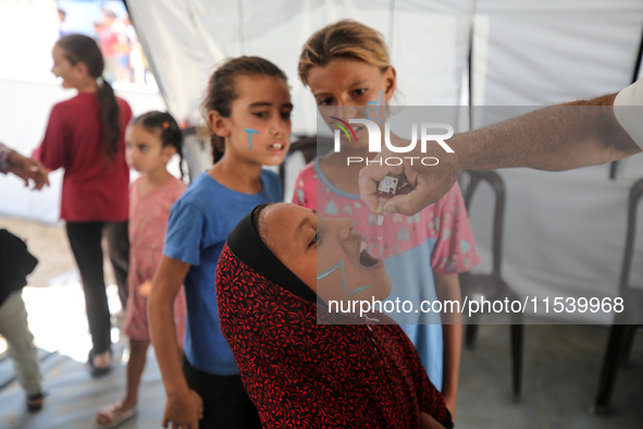 A Palestinian child receives a polio vaccination in the UK-MED field hospital in Zawayda, Gaza Strip, on September 2, 2024, amid the ongoing...