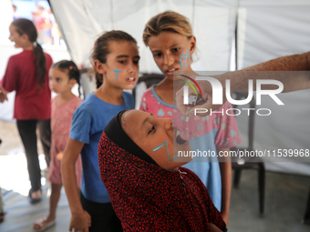 A Palestinian child receives a polio vaccination in the UK-MED field hospital in Zawayda, Gaza Strip, on September 2, 2024, amid the ongoing...