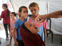 A Palestinian child receives a polio vaccination in the UK-MED field hospital in Zawayda, Gaza Strip, on September 2, 2024, amid the ongoing...