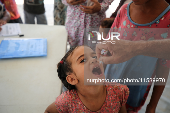 A Palestinian child receives a polio vaccination in the UK-MED field hospital in Zawayda, Gaza Strip, on September 2, 2024, amid the ongoing...